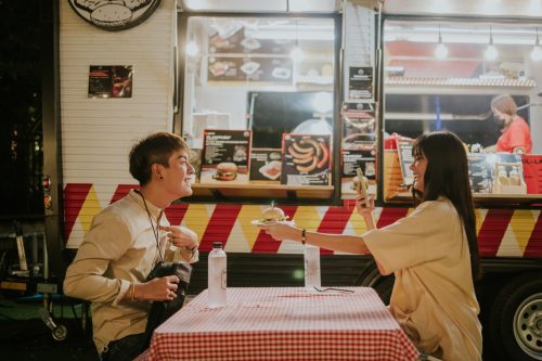young couple going on a date at a food truck