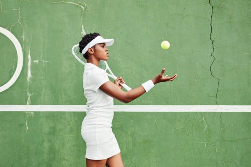 young black woman playing tennis
