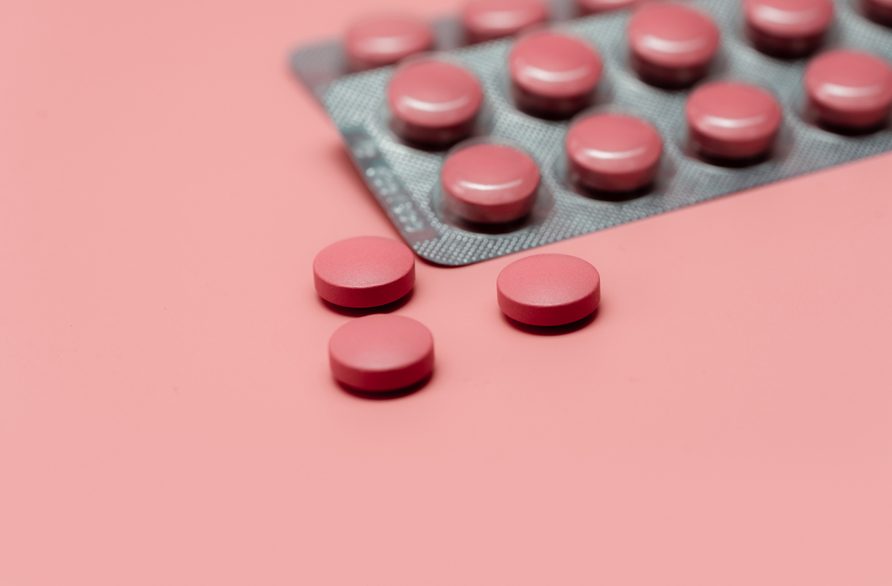 Pink tablets on a pink background. 