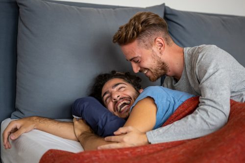 young gay couple in bed
