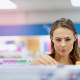 Woman buying medicine in a pharmacy.