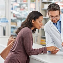 Pharmacist talking to a customer.