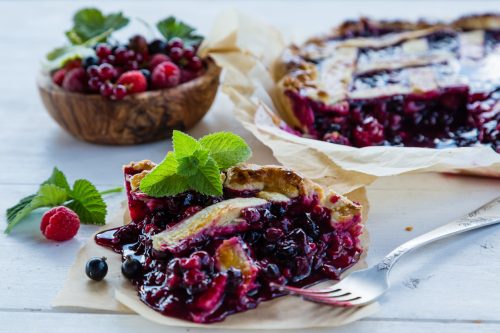 Traditional berry pie on rustic background, copy space