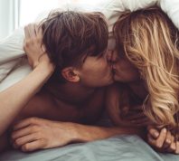 couple kissing in the bedroom