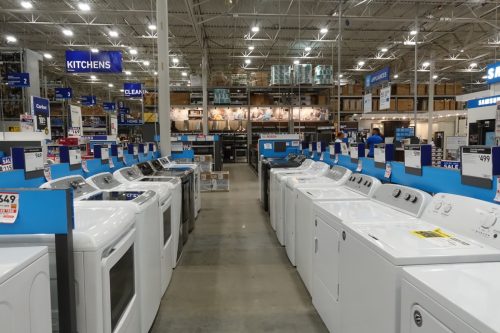 A row of washer and dryers for sale at Lowes hardware store appliance department.