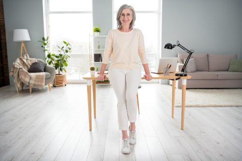 Classy older woman in white outfit and sneakers