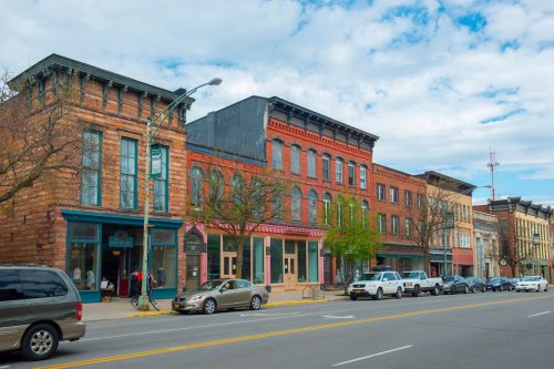 Historic sandstone and brick commercial buildings with Italianate style on Market Street at Main Street in downtown Potsdam, Upstate New York