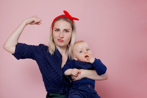 woman with baby girl in the "yes you can" pose