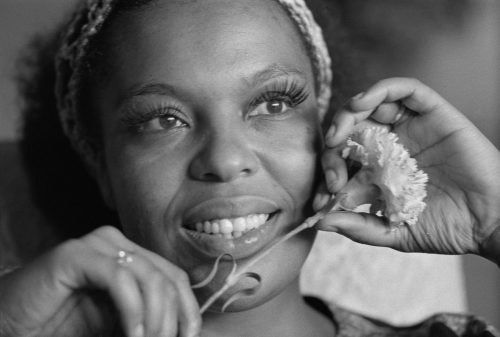 Roberta Flack photographed posing with a flower in London in 1972