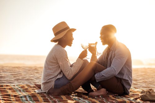 couple sipping wine on the beach