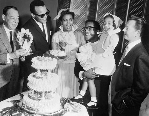 Sammy Davis Jr. and Loray White photographed at their wedding with Joe E. Lewis, Harry Belafonte, and Donald O'Connor in 1958