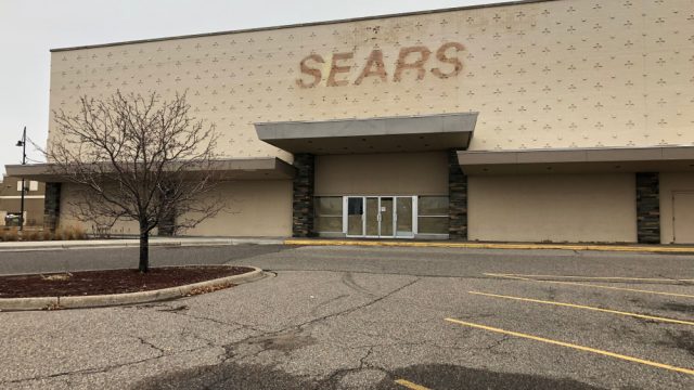 The parking lot of a closed down Sears location