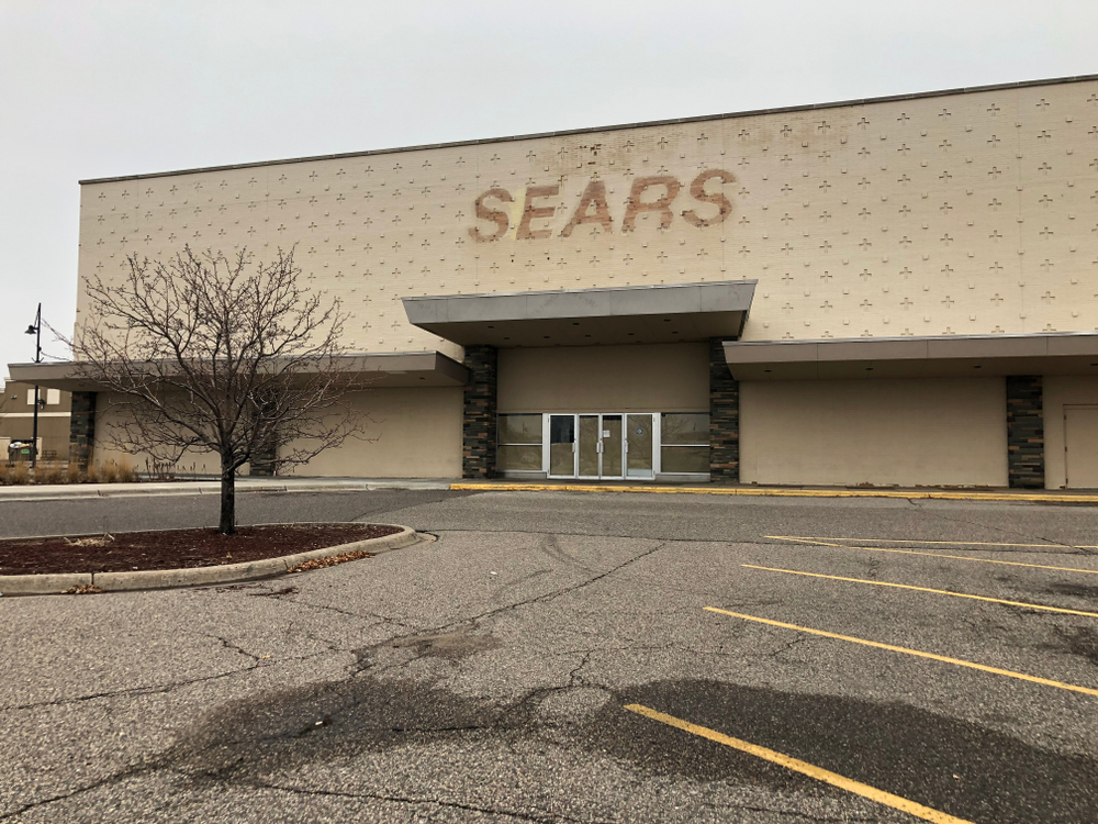 The parking lot of a closed down Sears location