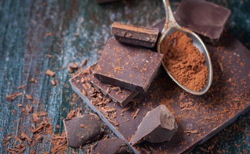 Dark chocolate bars and spoonful of cocoa powder