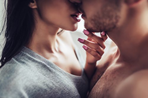 close up of man and woman kissing