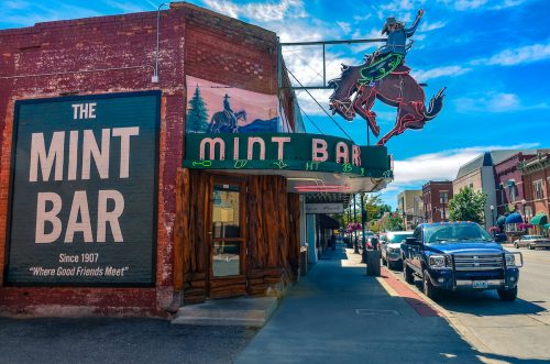The Mint Bar, a historic whiskey bar with a neon cowboy sign, in downtown Sheridan, Wyoming.