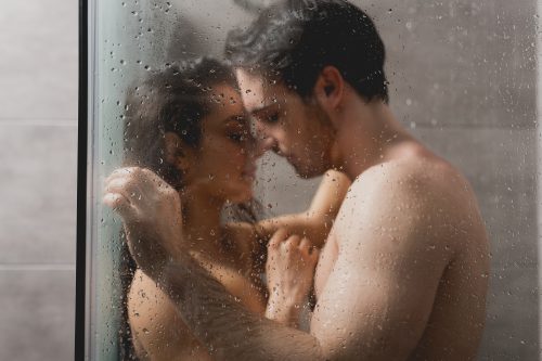 Man and woman fooling around in shower