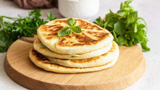 Frying,Flatbread,Filled,With,Fresh,Herbs,And,Cheese.,Khychiny,Or