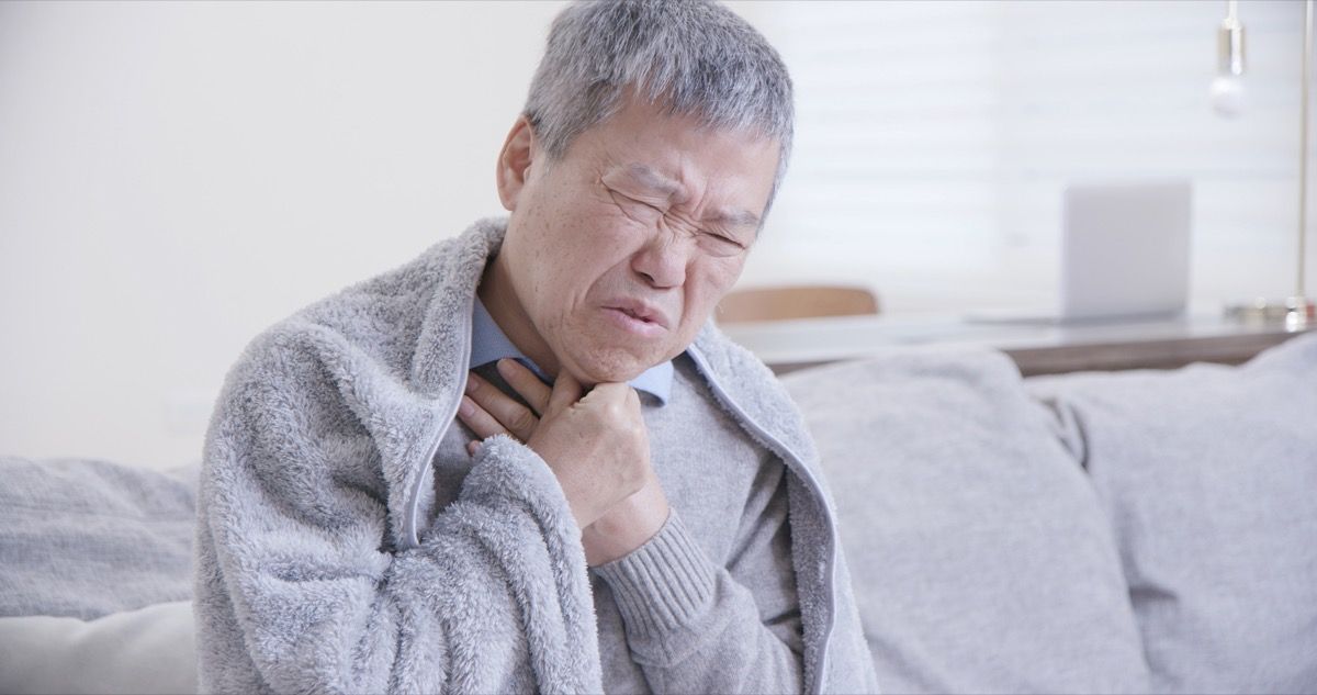 Older Man Clutching at Throat