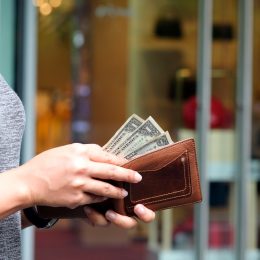 woman with dollar bills in wallet