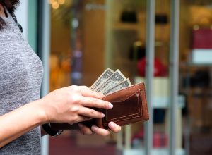 woman with dollar bills in wallet
