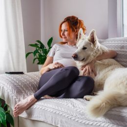 woman at peace with dog on couch