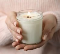 Woman holding a white candle.