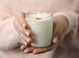 Woman holding a white candle.