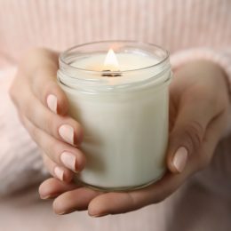 Woman holding a white candle.