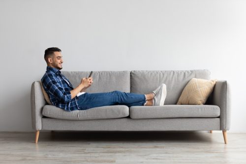 Man Texting While on the Couch