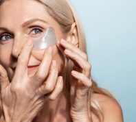 Older Woman Applying Eye Products