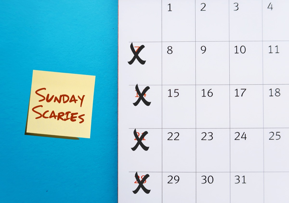Calendar on blue background crosson Sunday with stick note SUNDAY SCARIES (Sunday blues) - feelings of intense anxiety or dread happen on day before head back to work, office or school