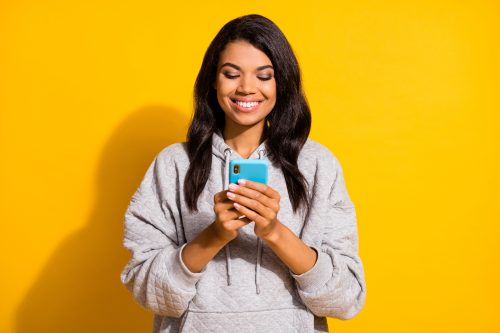 woman smiling on her phone
