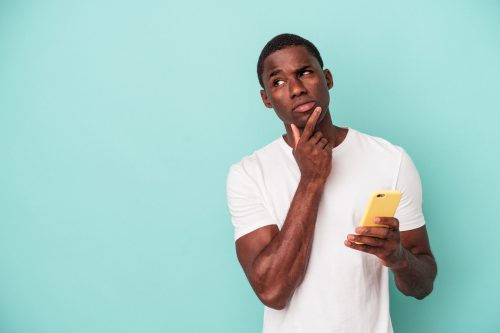 man looking confused after reading some unpopular opinions on his phone