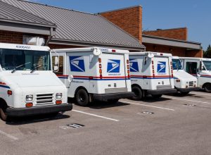 Indianapolis - Circa August 2019: USPS Post Office Mail Trucks. The Post Office is responsible for providing mail delivery IV