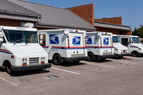 Indianapolis - Circa August 2019: USPS Post Office Mail Trucks. The Post Office is responsible for providing mail delivery IV
