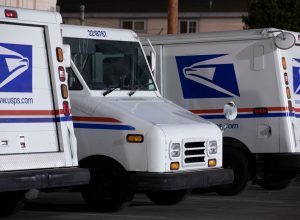 Azusa, California / USA - August 15, 2020: USPS (United States Parcel Service) mail delivery trucks sit parked for the night.