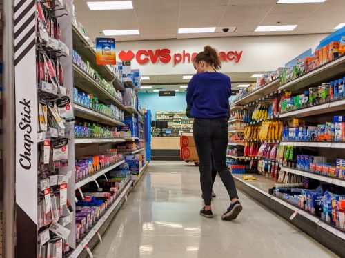 Woman browsing medicine and supplements in the CVS pharmacy inside a Target store.