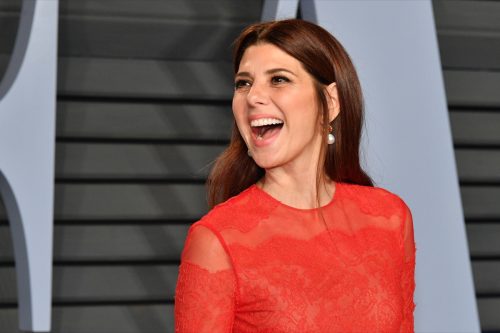 Marisa Tomei wearing bright red at an event. 