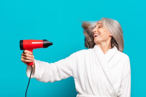 woman blow dry gray hair