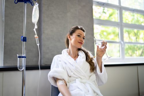 Woman receiving iv therapy for hangover. 