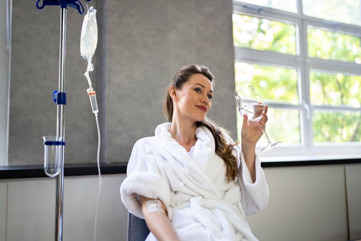 Woman receiving iv therapy for hangover.