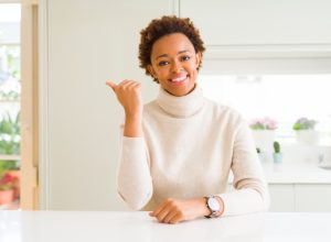 Woman wearing a turtleneck in the kitchen.