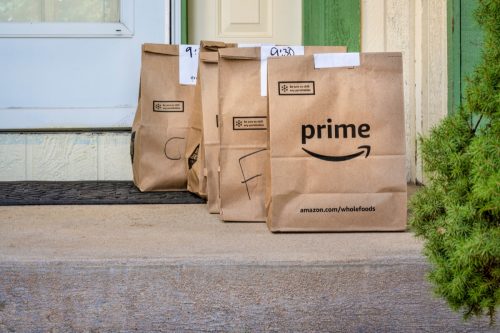 Fort Collins, CO, USA - March 31, 2020: Brown bags with groceries delivered to home from Whole Food Market and ordered through Amazon Prime. Online shopping during coronavirus pandemic.