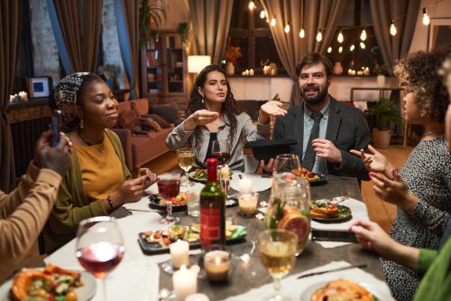 people playing a party game at a dinner party