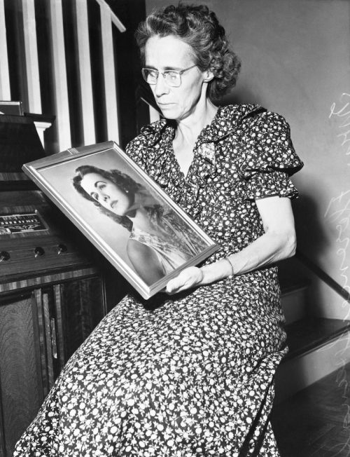 Florence Spangler holding a photo of Jean Spangler circa 1949