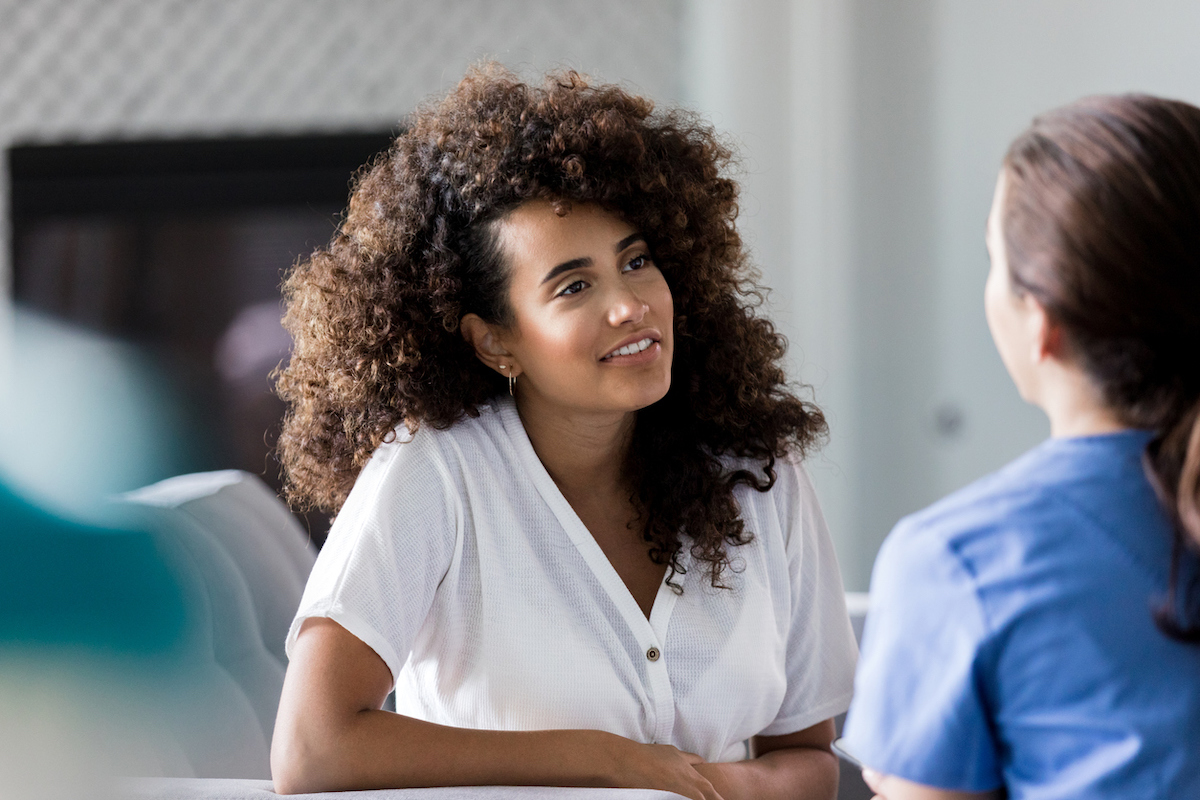 Two female friends sitting and chatting.