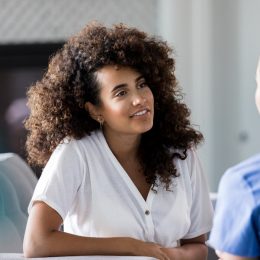 Two female friends sitting and chatting.