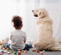 little girl sitting with her dog