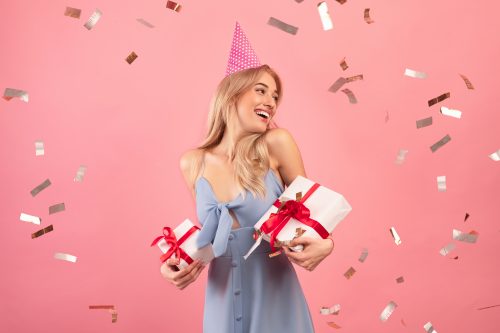 woman holding presents and celebrating her birthday